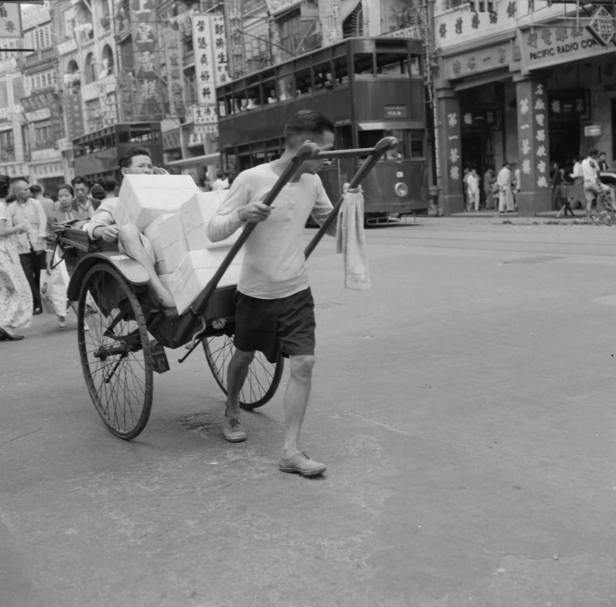 【JPG清晰版】._香港，一名男子拉着人力车，载着顾客和箱子