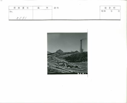 工业区烟囱与原木堆景观.jpg