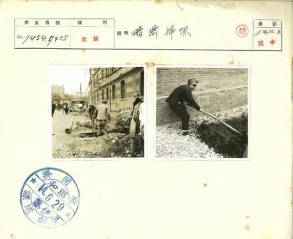 工人砖墙旁处理黑色物质.jpg