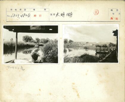 河滨停船与远山房屋景色.jpg