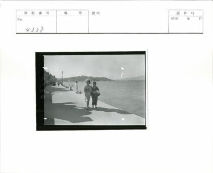 海边散步的持伞女人.jpg