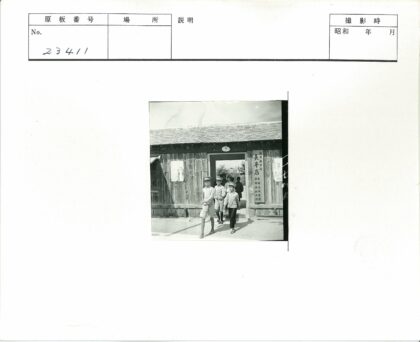 亚洲学校制服学生走出木屋建筑.jpg