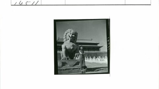 传统建筑前妇女与狮子雕像.jpg