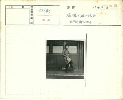 传统服装人物持布站木门前.jpg