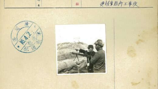 军装男子指远处建筑.jpg