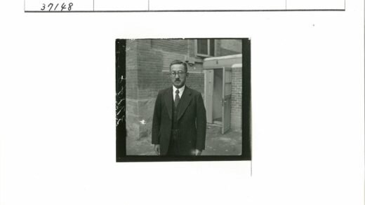商务男士站在砖墙建筑前.jpg
