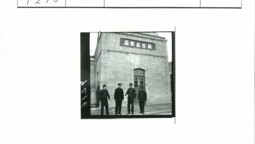 四名制服男子在砖房前合影.jpg
