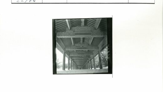 复古长廊横梁雕花与绿树景观.jpg
