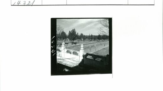 多云天空下传统建筑与石栏风景.jpg