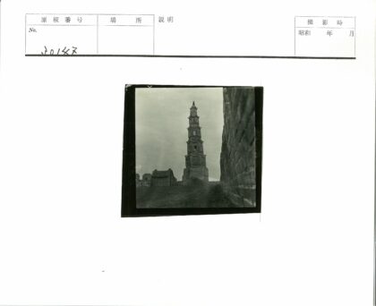 多云天空下的古老石塔与石墙.jpg
