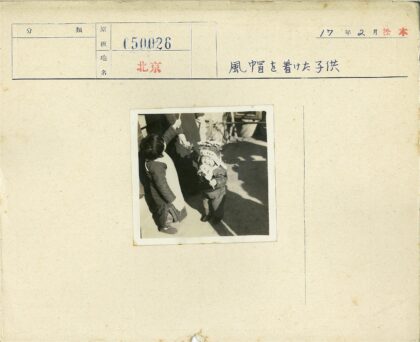 戴帽孩子与持棍孩童户外玩耍.jpg