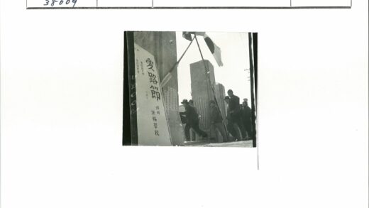 户外队伍高举旗帜经过石柱碑文.jpg