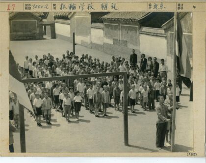 旗杆前的人群与砖泥建筑.jpg