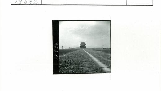 田野小径尽头的亚洲传统建筑.jpg