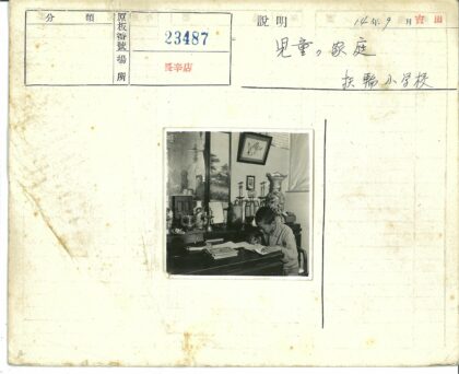 男孩书桌前写作与军帽陈设.jpg
