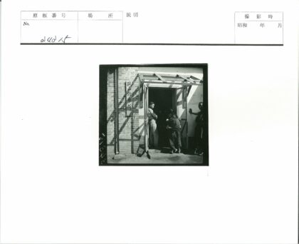 砖砌建筑前背孩子的行人.jpg