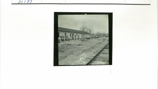 铁路旁单层斜顶建筑与枯树.jpg