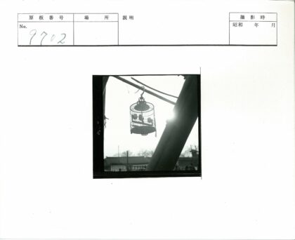 鸟笼悬挂天空映衬建筑树木.jpg