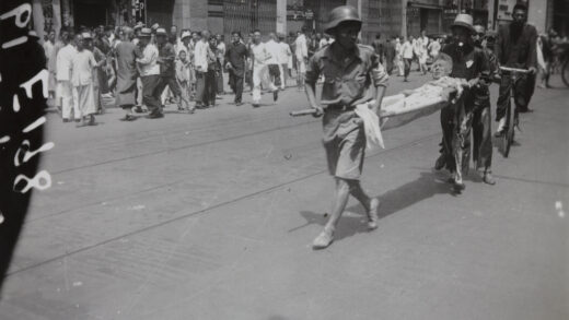 【jpg清晰版】1937年8月23日上海先施公司与永安百货遭轰炸后一名伤者躺在担架上.jpg