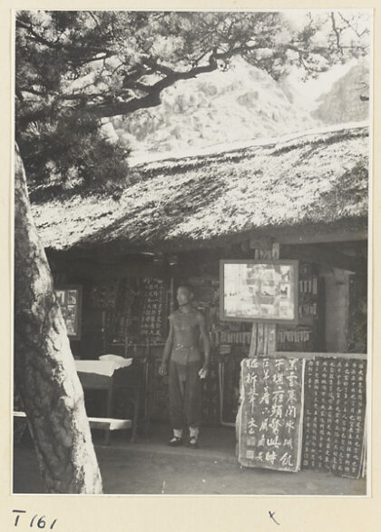 【jpg清晰版】男子站在泰山前建筑的照片和碑文展示旁.jpg